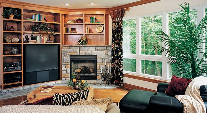 A living room with a fireplace and some windows