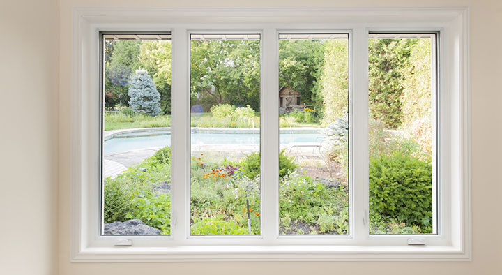 A window of a house from the inside with trees on the outside