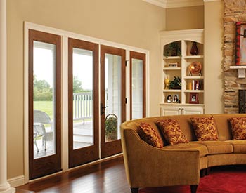 A front gate of a house from the inside with a couch in front.