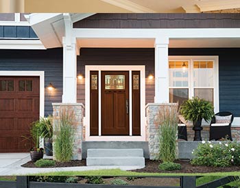 The front gate of a beautiful house with plants in the front